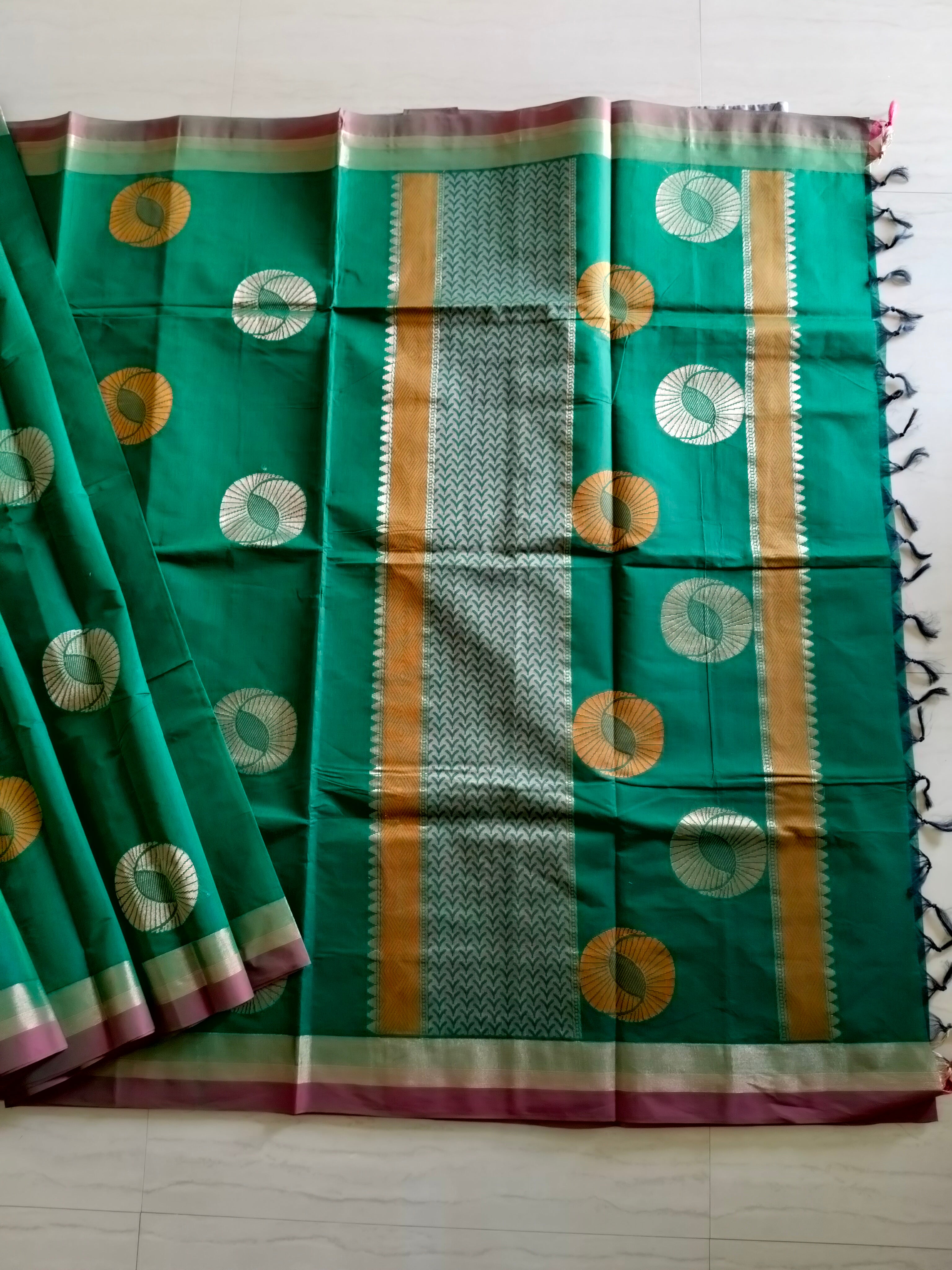Cotton saree with golden zari & orange buttas.