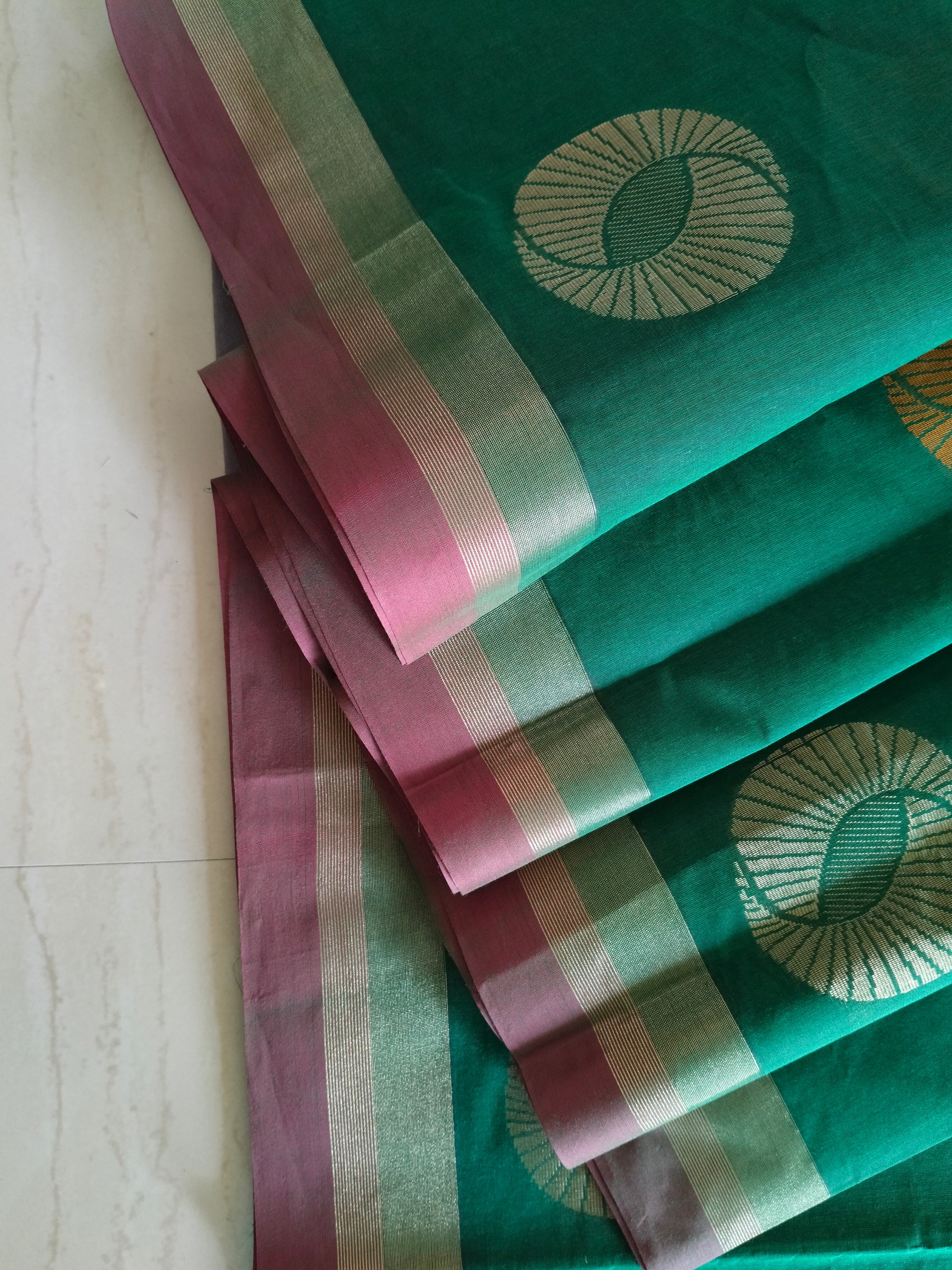 Cotton saree with golden zari & orange buttas.