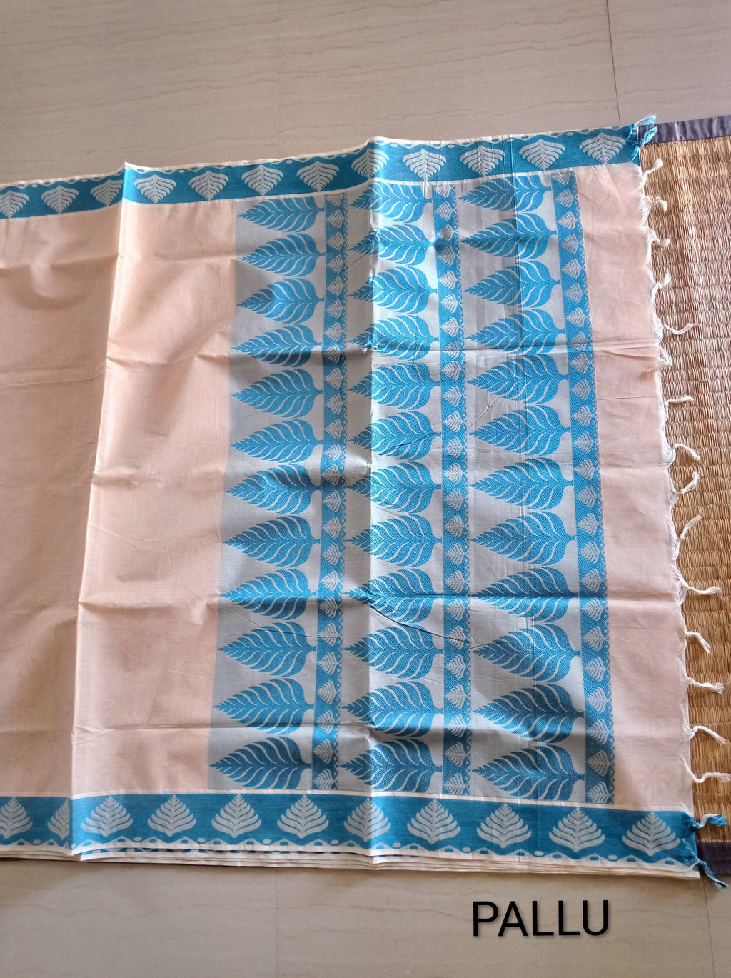 Pastel cream embossed cotton saree with blue thread work